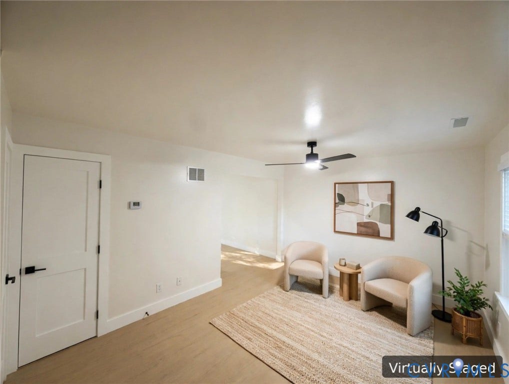 Light wood-finish flooring throughout, complemented by a contemporary ceiling fan with integrated lighting