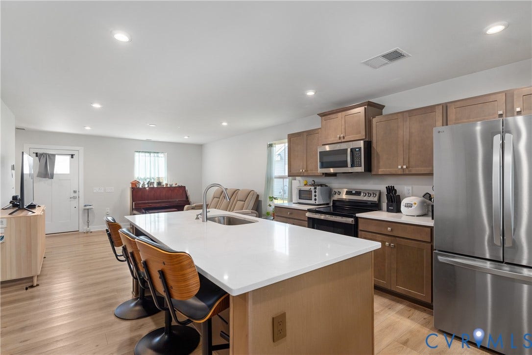 7580 Southamptonshire Way, Autumn Pines, New Kent, VA 23124 Kitchen island with white countertop, stainless steel appliances, wood-finish cabinetry, and recessed lighting