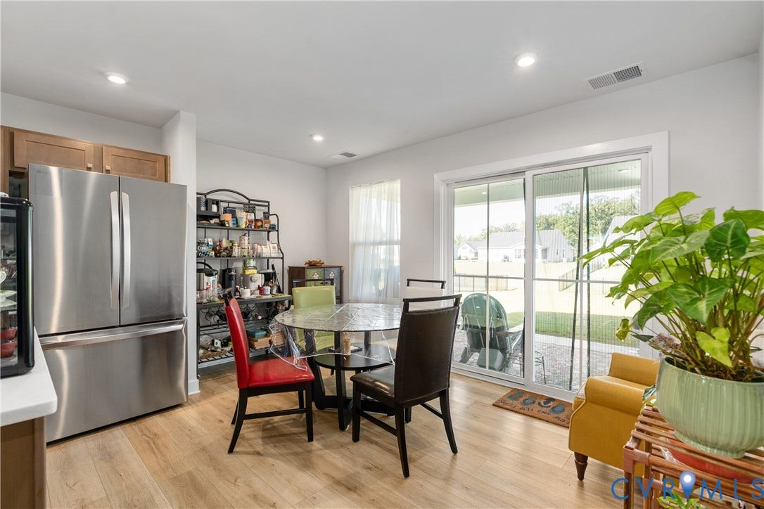 7580 Southamptonshire Way, Autumn Pines, New Kent, VA 23124 Wood-finish flooring, recessed lighting, white walls, and a glass sliding door leading to an outdoor patio