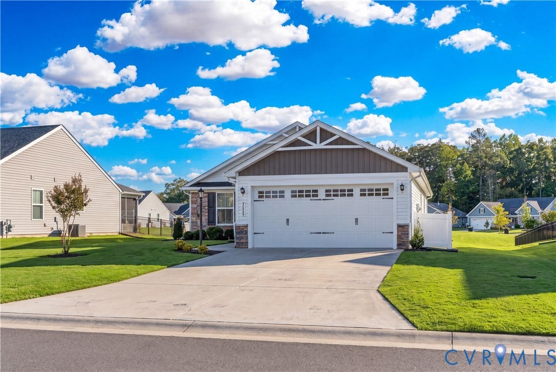 7580 Southamptonshire Way, Autumn Pines, New Kent, VA 23124 Exterior featuring siding and stone accents, an attached two-car garage, concrete driveway, and front landscaping