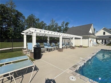 7580 Southamptonshire Way, Autumn Pines, New Kent, VA 23124 Swimming pool with stone coping and a surrounding concrete deck