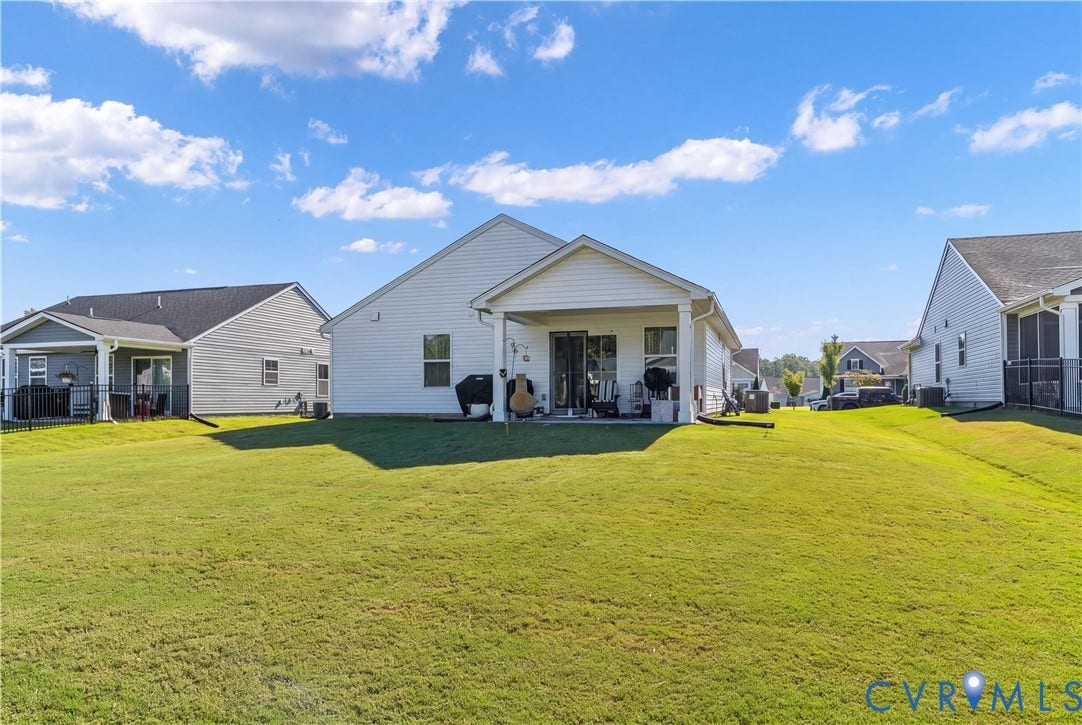 7580 Southamptonshire Way, Autumn Pines, New Kent, VA 23124 Expansive green space featuring a covered patio, sliding glass door access, and vinyl siding