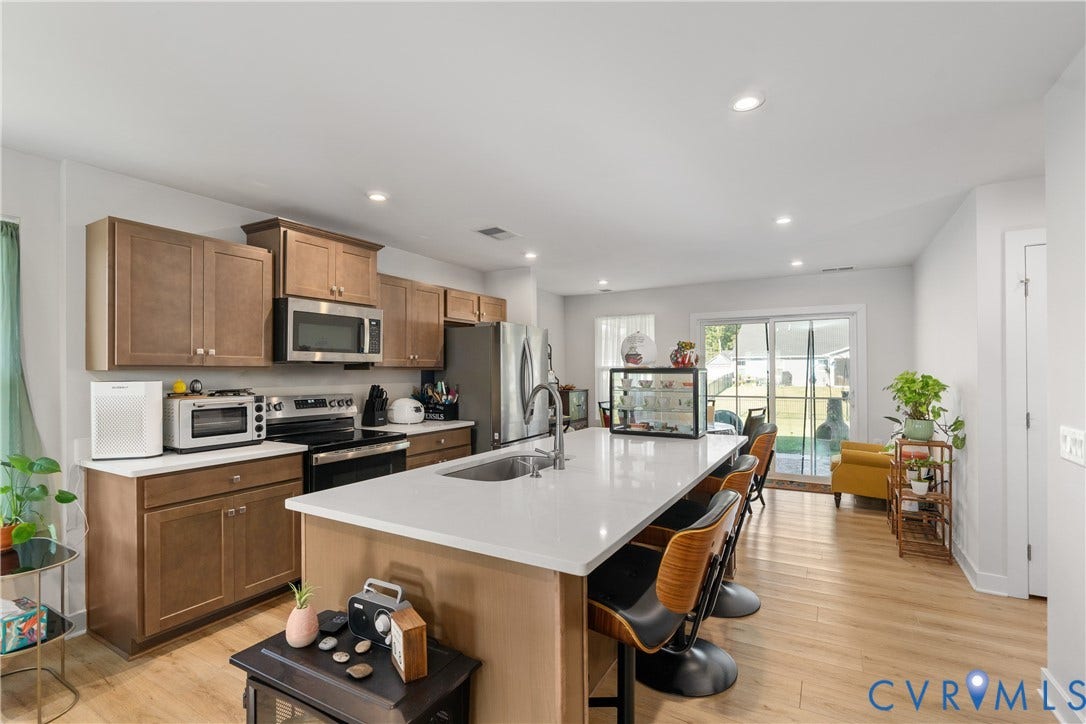7580 Southamptonshire Way, Autumn Pines, New Kent, VA 23124 Kitchen featuring wood-finish flooring, recessed lighting, and a large island with a built-in sink