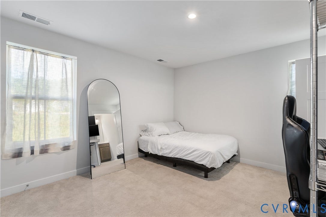 7580 Southamptonshire Way, Autumn Pines, New Kent, VA 23124 Neutral-toned wall paint and carpeting, recessed lighting, and a single window offering natural light