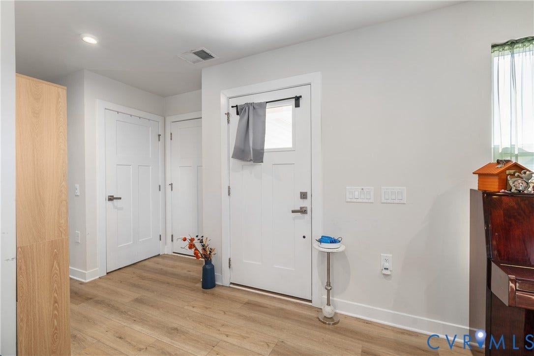 7580 Southamptonshire Way, Autumn Pines, New Kent, VA 23124 Entryway featuring wood-finish flooring, white paneled doors, and light-toned walls