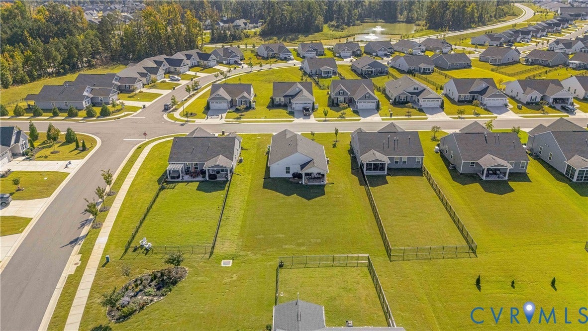 7580 Southamptonshire Way, Autumn Pines, New Kent, VA 23124 Residential neighborhood featuring single-story homes, paved streets, and a pond surrounded by trees