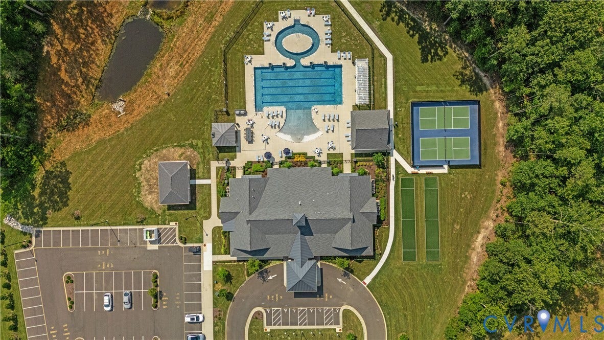 7580 Southamptonshire Way, Autumn Pines, New Kent, VA 23124 Community amenities featuring an outdoor pool, separate lap pool, tennis courts, and bocce ball courts, alongside a large parking area