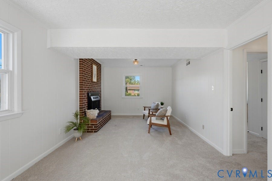 20306 Sheffield Place, Laurel Branch Farms, South Chesterfield, VA 23803 Brick fireplace with a black firebox, light-colored carpeting, white paneled walls, and white window trim
