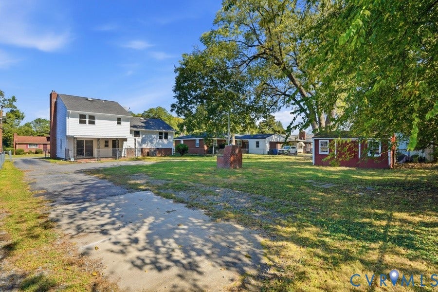 20306 Sheffield Place, Laurel Branch Farms, South Chesterfield, VA 23803 Expansive rear yard with a detached storage shed, mature trees, and a paved driveway