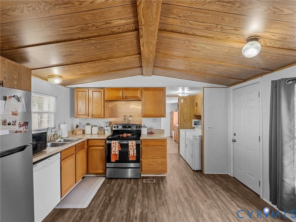 17009 Lansmill Drive, South Chesterfield, VA 23834 Wood-finish flooring throughout, wood-paneled vaulted ceiling, stainless steel range, and wood-finish cabinetry