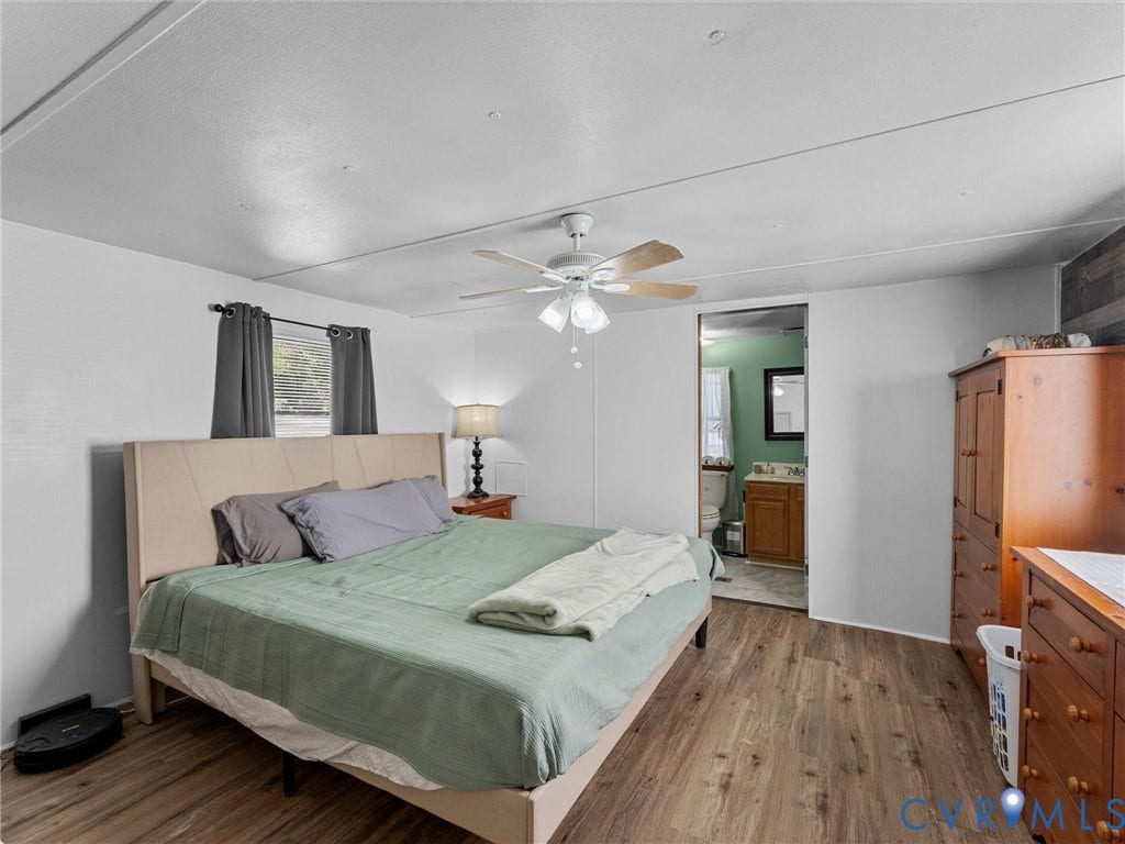 17009 Lansmill Drive, South Chesterfield, VA 23834 Wood-finish flooring throughout, ceiling fan with integrated lighting, and a window with dark drapery