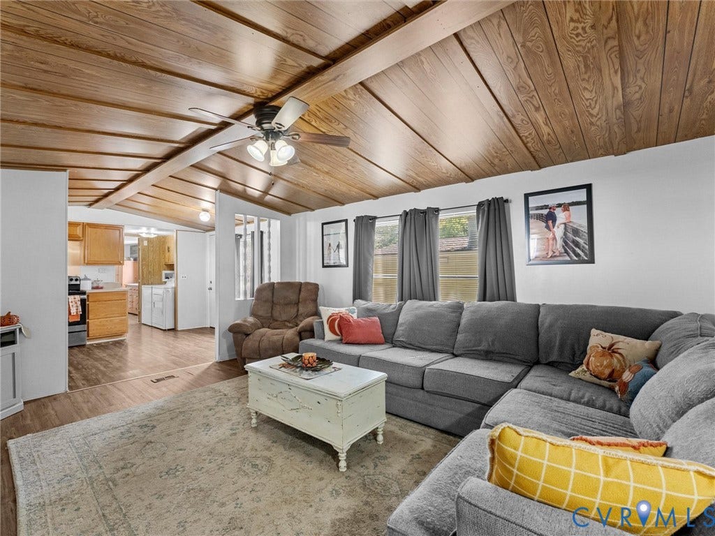 17009 Lansmill Drive, South Chesterfield, VA 23834 Vaulted wood-finish ceiling with exposed beams, ceiling fan with integrated lighting, wood-finish flooring, and white wall finishes
