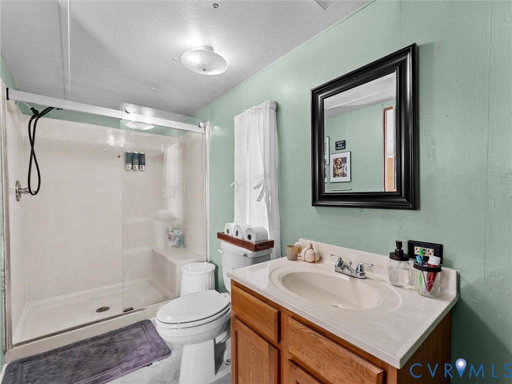 17009 Lansmill Drive, South Chesterfield, VA 23834 Shower with sliding glass doors and built-in bench