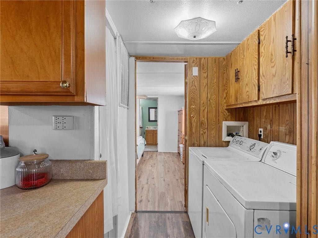 17009 Lansmill Drive, South Chesterfield, VA 23834 Laundry area featuring wood-finish wall paneling, overhead cabinetry, and a ceiling-mounted light fixture