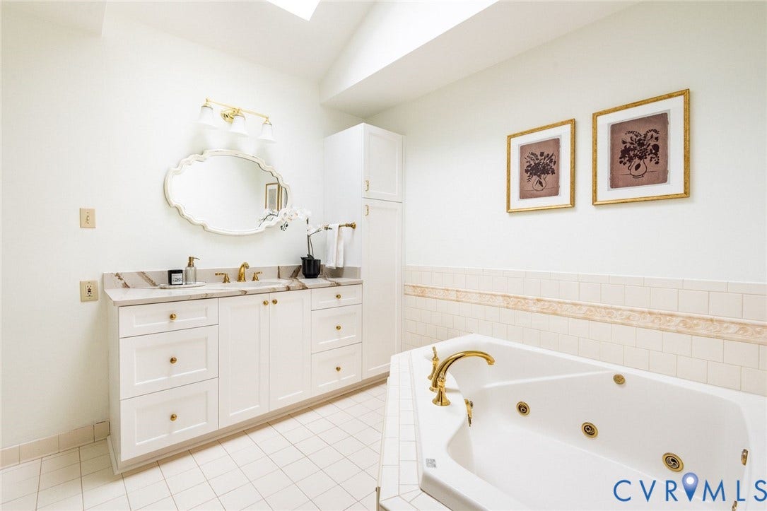 207 Tarrytown Drive, Sleepy Hollow, Henrico, VA 23229 Primary ensuite bathroom with garden jacuzzi bath tub, glass shower, skylight and custom vanity.