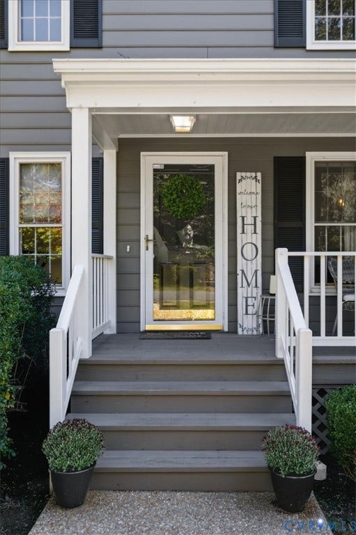 863 Watch Hill Road, Midlothian, VA 23114 Front exterior featuring gray siding, white window trim, dark window shutters, a storm door, and a covered porch with white railings