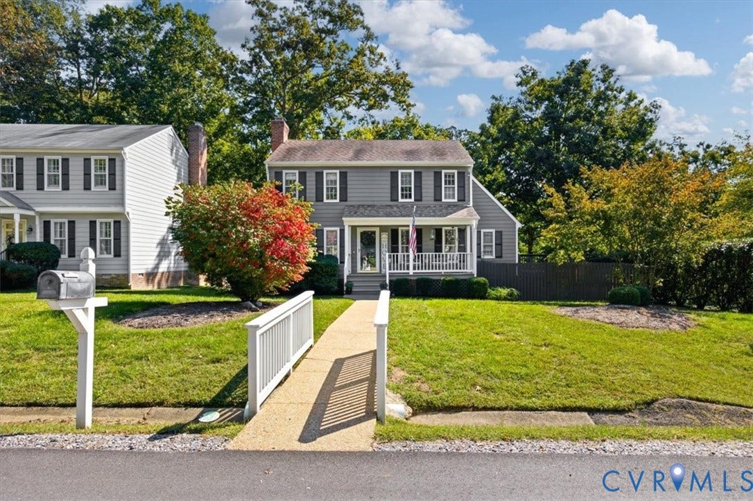863 Watch Hill Road, Midlothian, VA 23114 Colonial-style residence featuring a manicured lawn, mature landscaping with seasonal foliage, a paved accessibility ramp with handrails, and a white mailbox at the property entrance