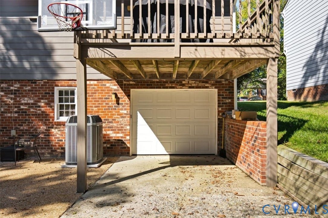 863 Watch Hill Road, Midlothian, VA 23114 Attached two-car garage with a paneled door, brick faade, and an exterior deck