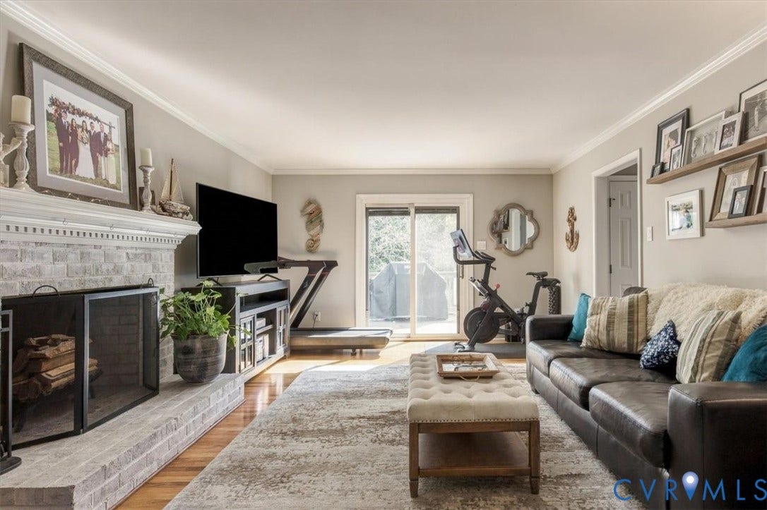 863 Watch Hill Road, Midlothian, VA 23114 White-painted brick fireplace with a detailed mantel, hardwood flooring, crown molding, and sliding glass doors to the exterior