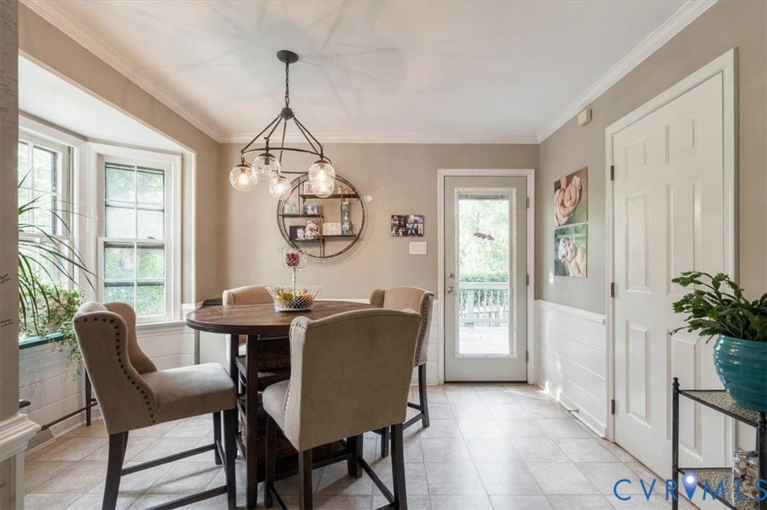863 Watch Hill Road, Midlothian, VA 23114 Bright dining area with large multi-pane windows flooding the space with natural light, complemented by a pendant light fixture with glass shades