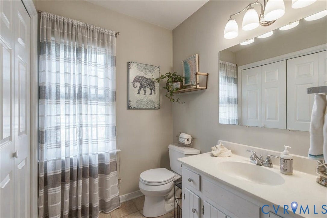 863 Watch Hill Road, Midlothian, VA 23114 Bright and spacious bathroom featuring a white vanity with dual-sink configuration, quartz countertop, and chrome faucetry