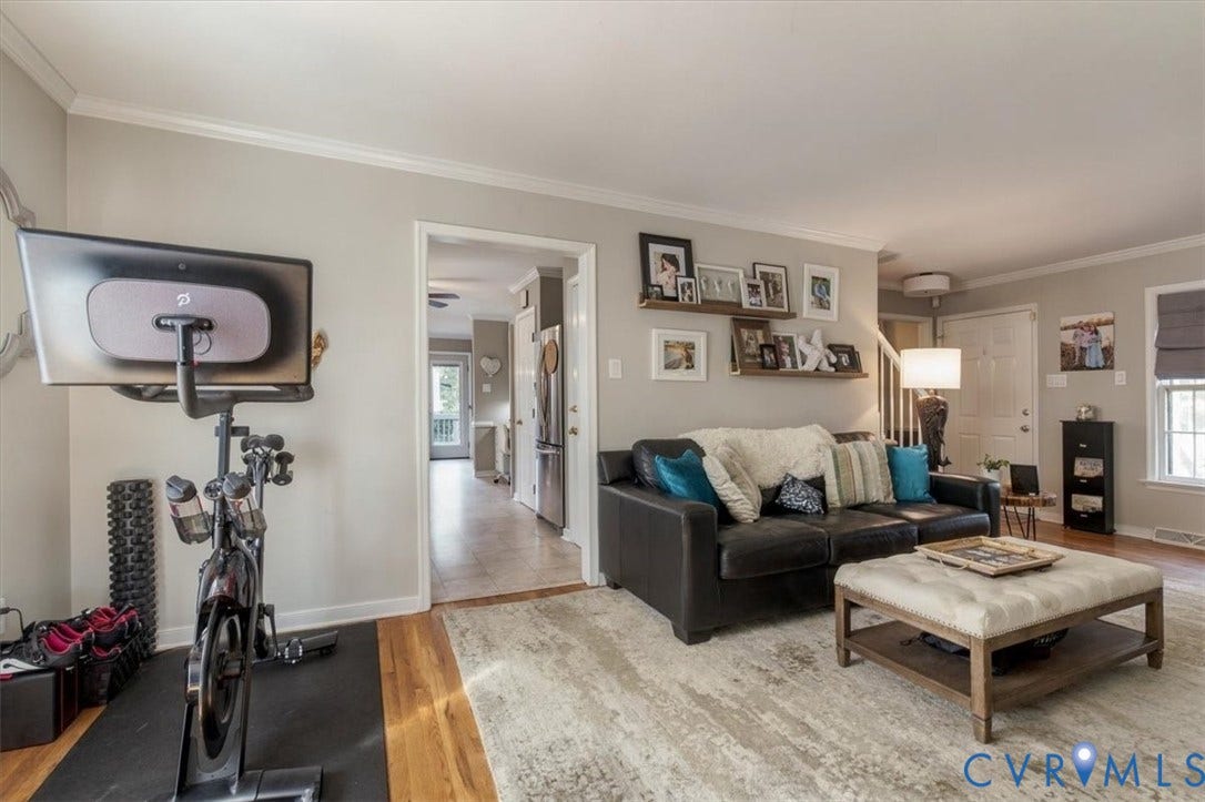 863 Watch Hill Road, Midlothian, VA 23114 Bright, open living space featuring hardwood flooring, neutral wall finishes, and abundant natural light from multiple windows