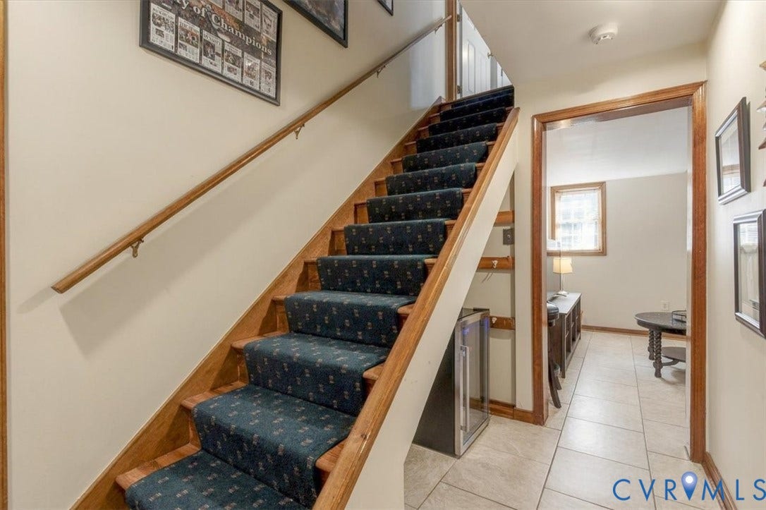 863 Watch Hill Road, Midlothian, VA 23114 Staircase with wood-finish treads and natural wood railings, complemented by dark patterned runner carpet