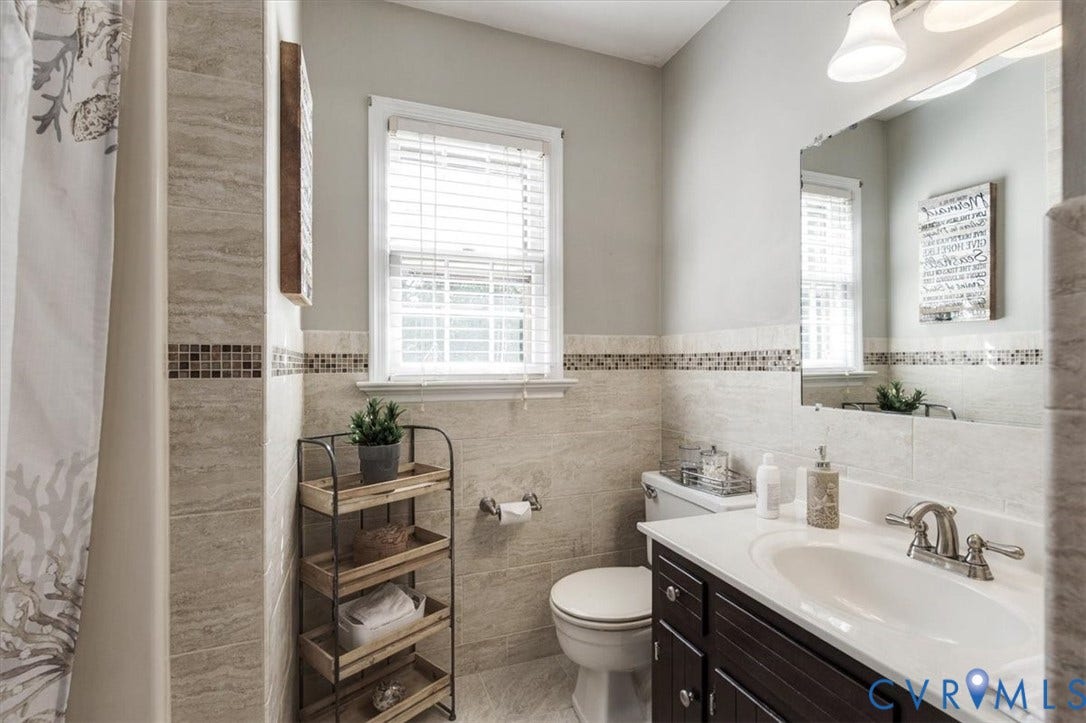 863 Watch Hill Road, Midlothian, VA 23114 Spa-inspired bathroom featuring a dual-sink vanity with dark cabinetry, white quartz countertops, and brushed nickel fixtures
