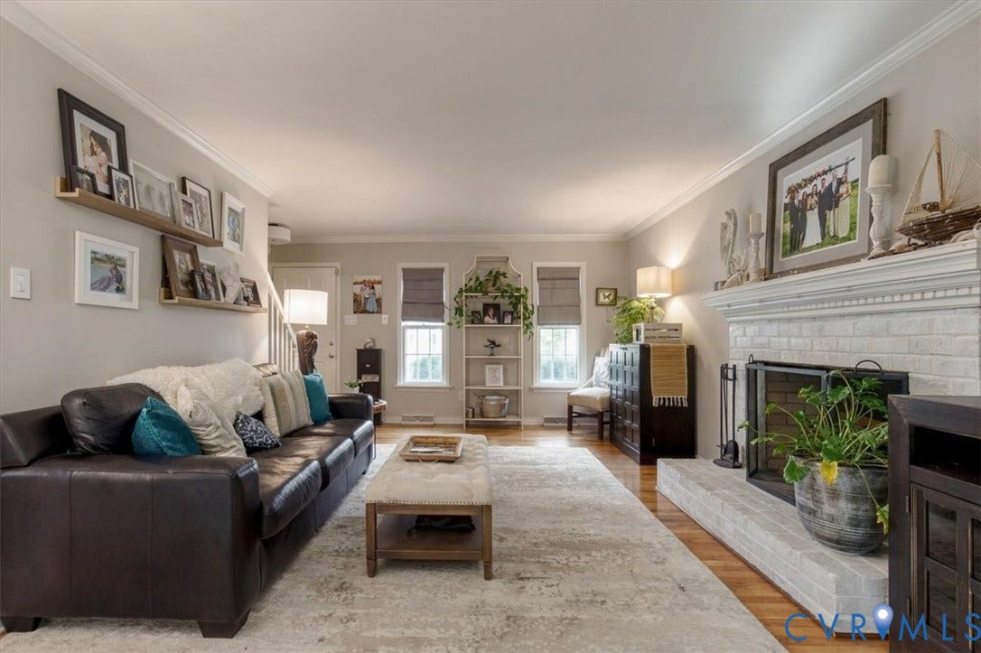863 Watch Hill Road, Midlothian, VA 23114 Bright and spacious living room anchored by a fireplace with white subway tile surround and dark cabinetry