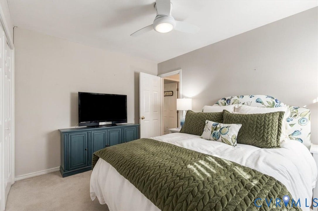 863 Watch Hill Road, Midlothian, VA 23114 Bright secondary bedroom featuring soft neutral walls, carpet flooring, and a ceiling fan with integrated lighting