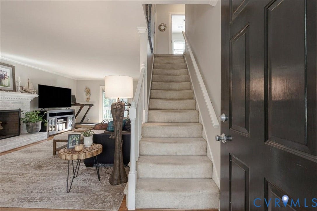 863 Watch Hill Road, Midlothian, VA 23114 Carpeted staircase with white balusters, wood-finish flooring, and a painted brick fireplace