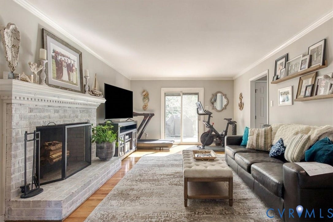 863 Watch Hill Road, Midlothian, VA 23114 Bright, open living room anchored by a linear fireplace with tile surround and built-in cabinetry