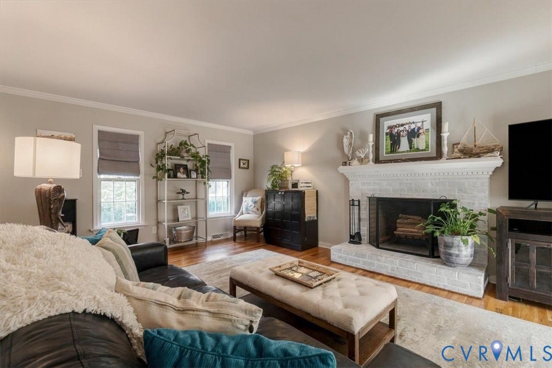 863 Watch Hill Road, Midlothian, VA 23114 Bright and inviting living room anchored by a gas fireplace with white tile surround and built-in cabinetry