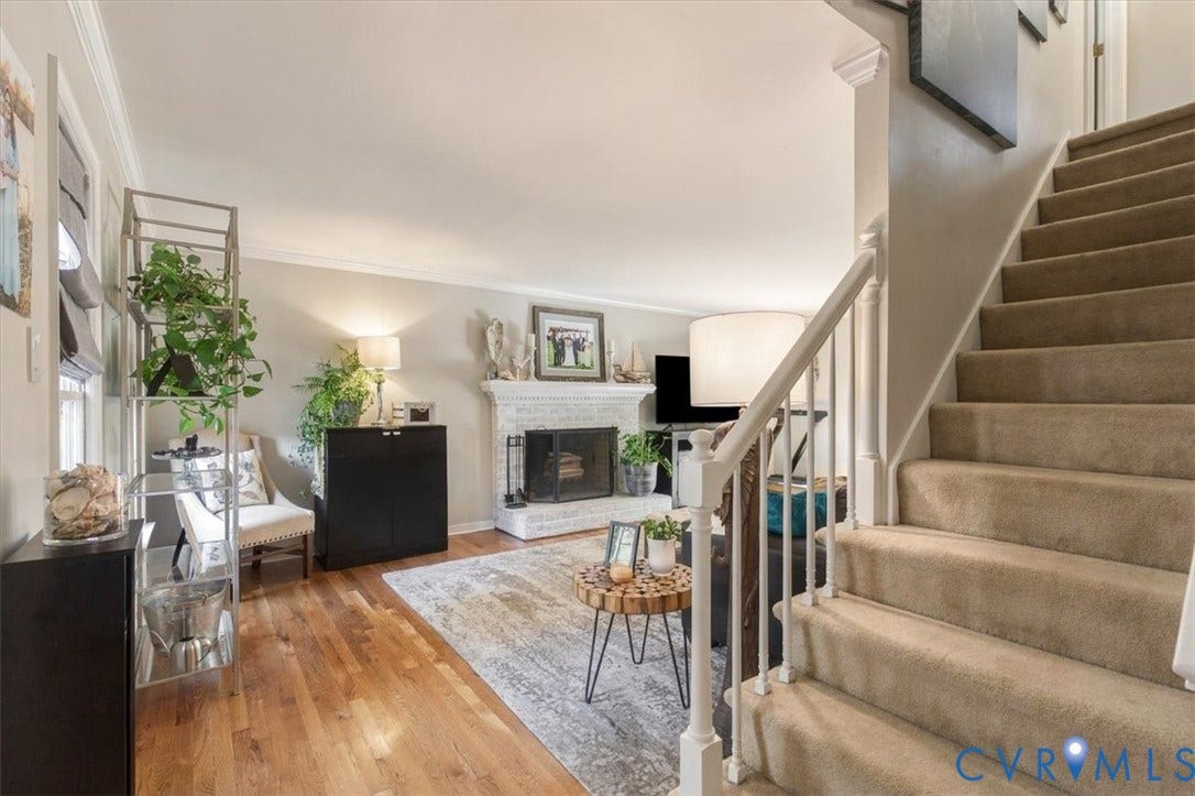 863 Watch Hill Road, Midlothian, VA 23114 Hardwood flooring complemented by a fireplace with a white brick surround and mantel