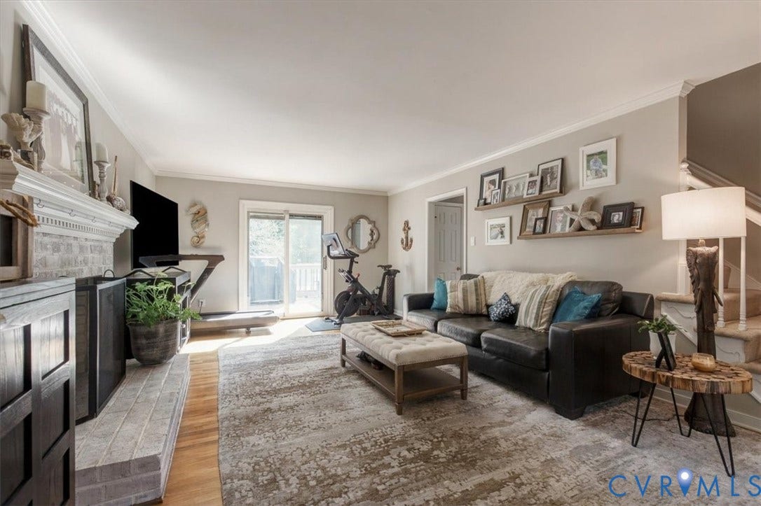 863 Watch Hill Road, Midlothian, VA 23114 Bright and spacious living room featuring hardwood and tile flooring, a working fireplace with decorative mantelpiece, and abundant natural light from French doors and multiple windows
