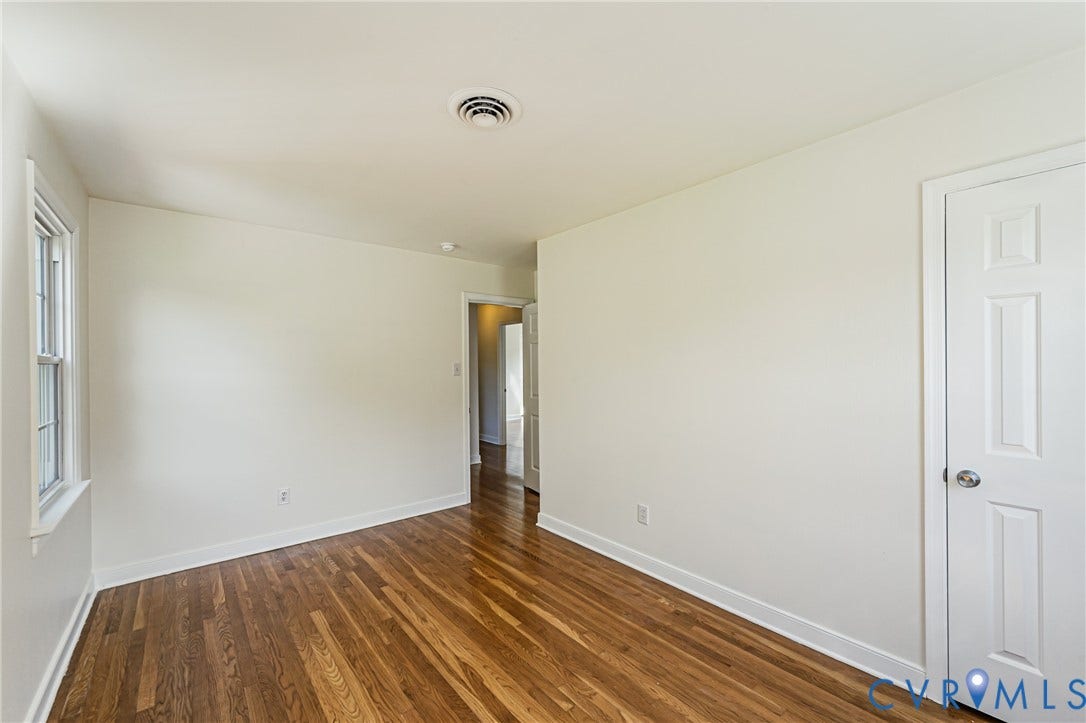 1608 Lochwood Drive, Henrico, VA 23238 Hardwood flooring throughout, white painted walls, and a multi-pane window