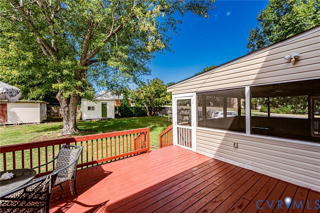 1608 Lochwood Drive, Henrico, VA 23238 Expansive wood-finish deck with red railings, leading to a screened porch with light-colored siding