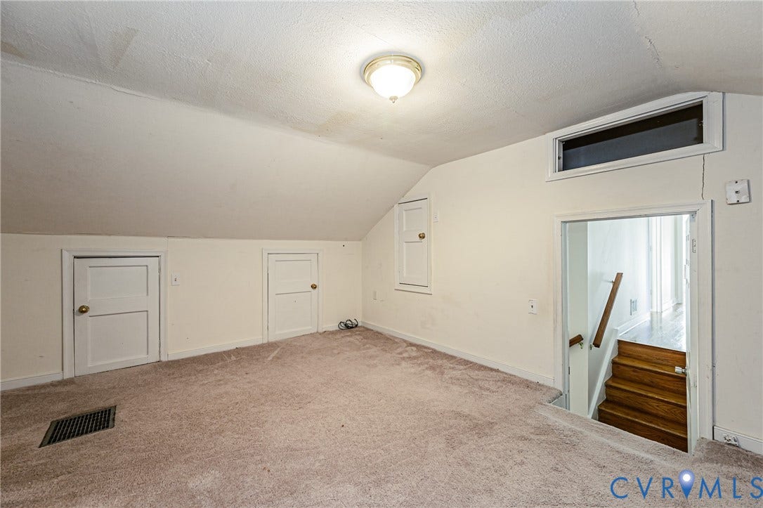 1608 Lochwood Drive, Henrico, VA 23238 Spacious upper-level room with angled ceiling, neutral carpeting, and multiple windows providing natural light
