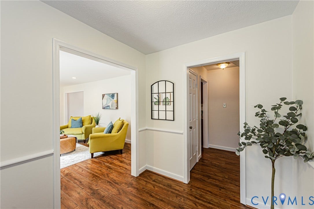 1608 Lochwood Drive, Henrico, VA 23238 Wood-finish flooring throughout, white wall paneling, and white trim accents
