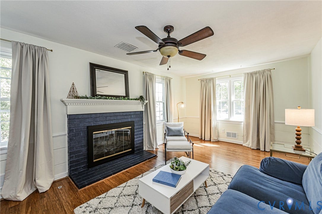 1608 Lochwood Drive, Henrico, VA 23238 Hardwood flooring throughout, a painted brick fireplace with a white mantel, and a ceiling fan