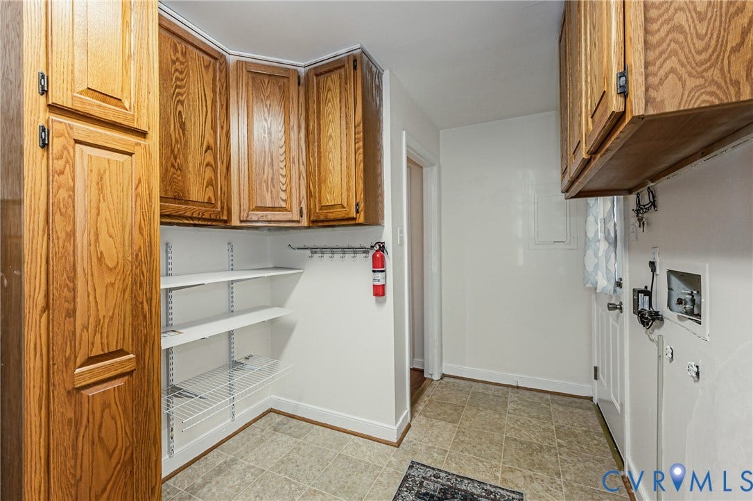 1608 Lochwood Drive, Henrico, VA 23238 Built-in cabinetry with wood-finish doors, corner wire shelving, and tile flooring