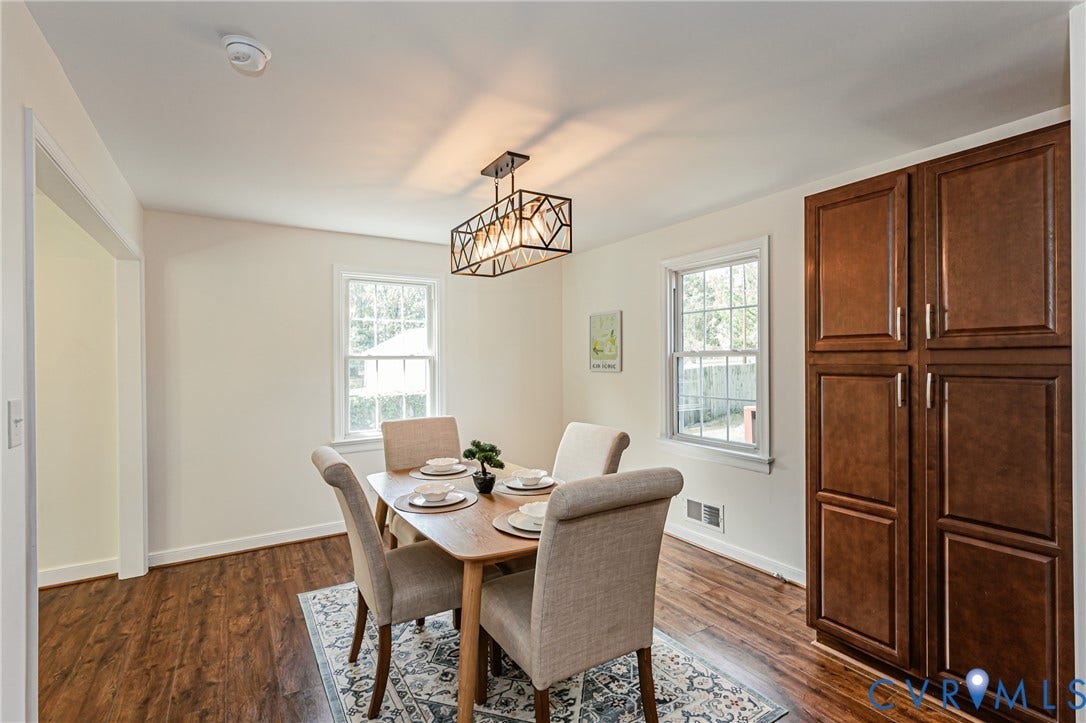 1608 Lochwood Drive, Henrico, VA 23238 Elegant dining room featuring hardwood flooring, a geometric pendant light fixture, and abundant natural light from dual windows