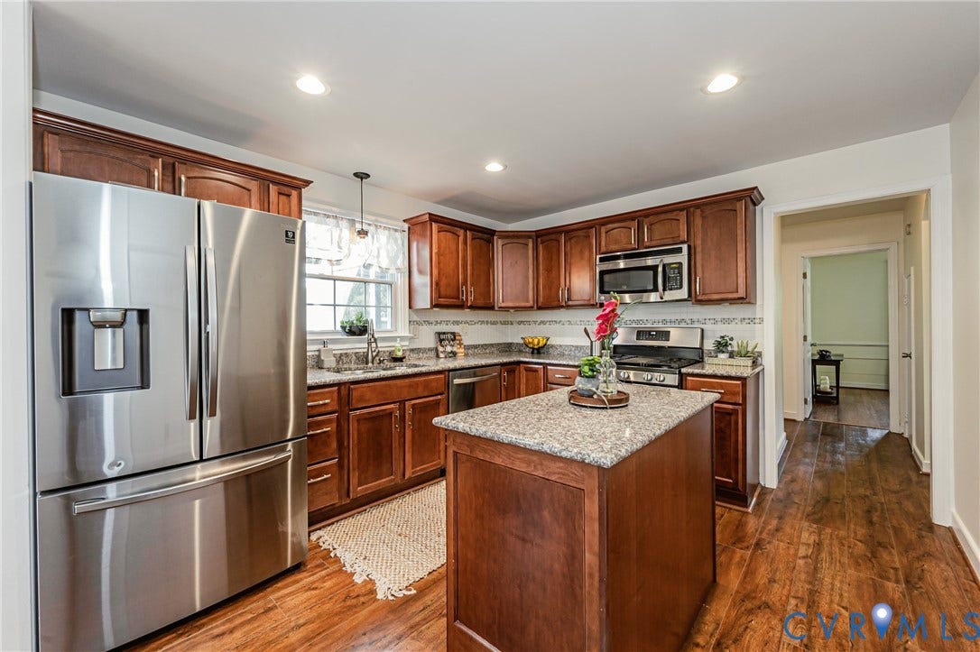 1608 Lochwood Drive, Henrico, VA 23238 Kitchen featuring wood-finish flooring, stainless steel appliances, wood cabinetry, granite countertops, and a center island