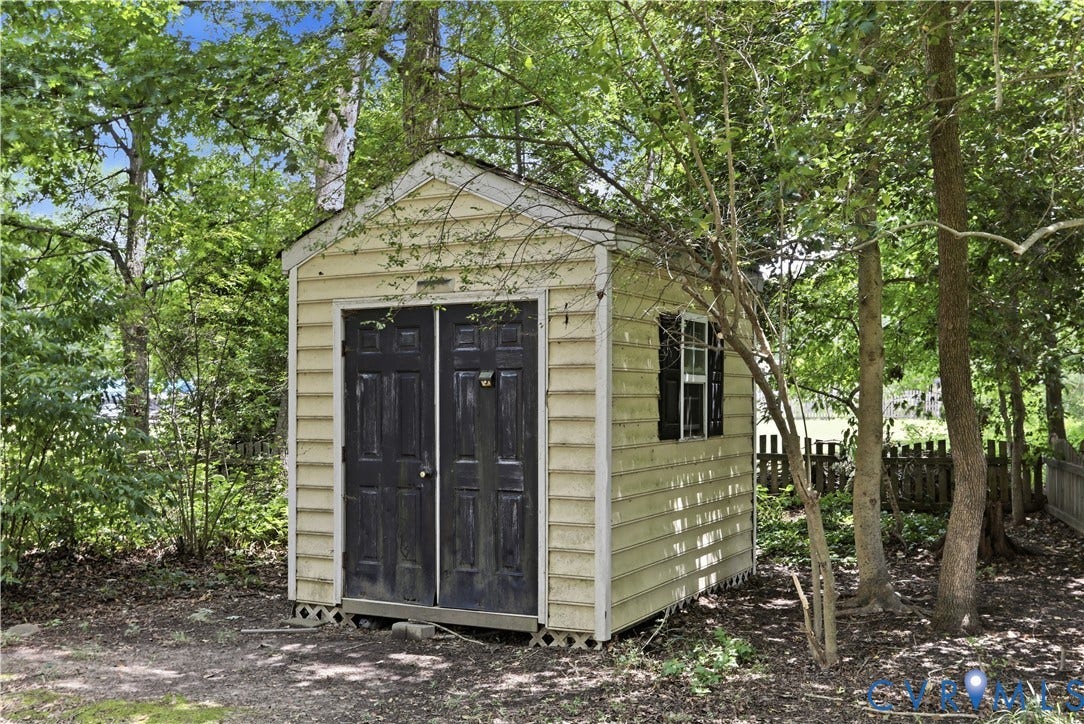 10721 Sheppards Way Drive, Sheppards Way, Glen Allen, VA 23060 Detached utility shed with double doors, a side window with shutters, and a slatted vinyl exterior