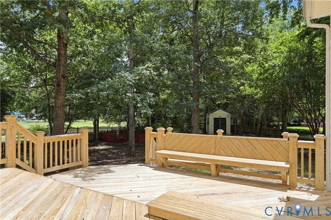 10721 Sheppards Way Drive, Sheppards Way, Glen Allen, VA 23060 Expansive wooden deck with an integrated bench, surrounded by mature trees, featuring a detached storage shed
