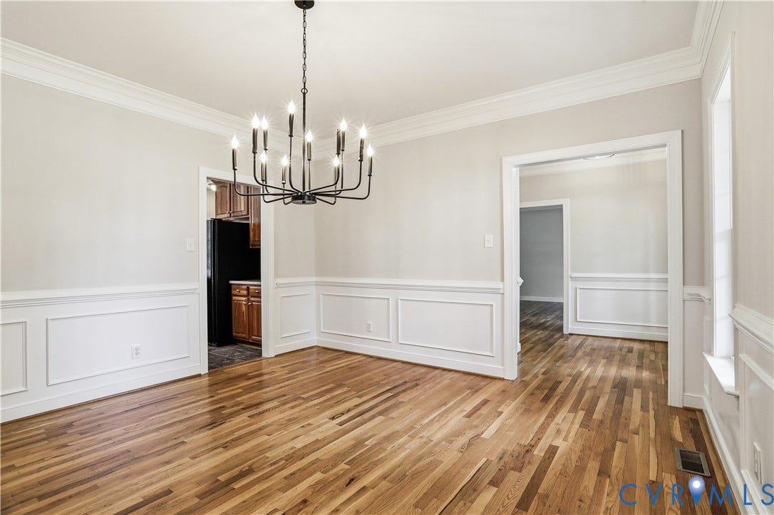 10721 Sheppards Way Drive, Sheppards Way, Glen Allen, VA 23060 Hardwood flooring, crown molding, chair rail, wainscoting, and a multi-arm chandelier