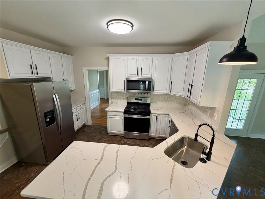 10721 Sheppards Way Drive, Sheppards Way, Glen Allen, VA 23060 Kitchen featuring white cabinetry, light-toned countertops, stainless steel appliances, and a tile backsplash