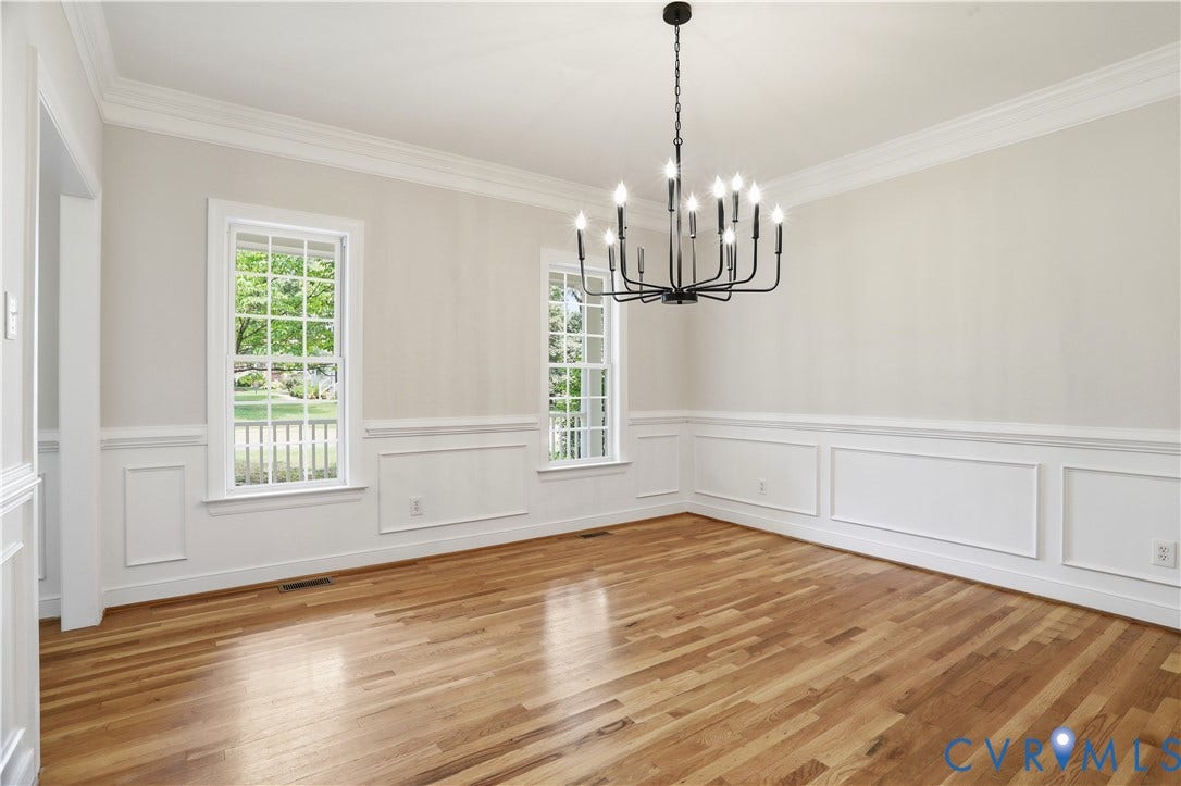 10721 Sheppards Way Drive, Sheppards Way, Glen Allen, VA 23060 Wood-finish flooring, white paneled wainscoting, crown molding, double-hung windows, and a black chandelier