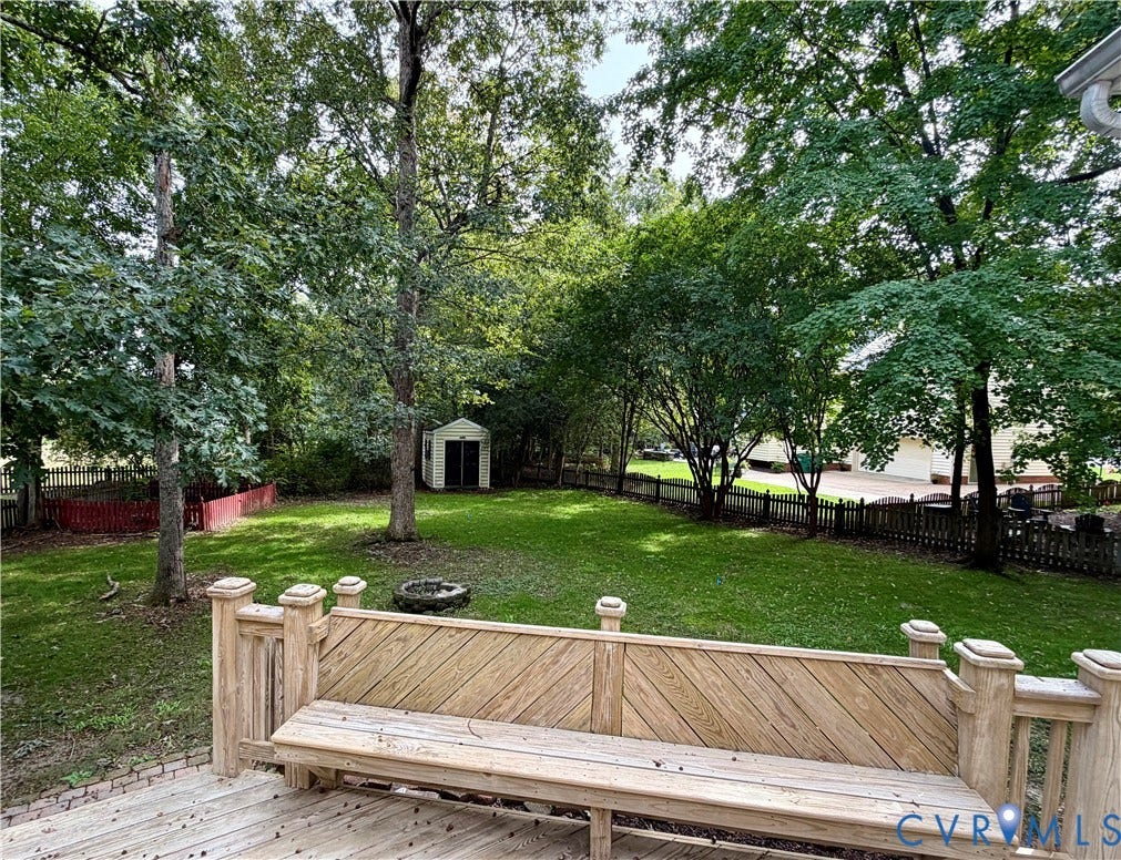 10721 Sheppards Way Drive, Sheppards Way, Glen Allen, VA 23060 Expansive backyard oasis featuring a manicured lawn, mature shade trees, and a custom wood-finish railing with stone post caps