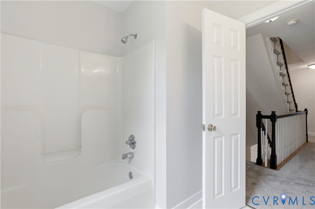 10721 Sheppards Way Drive, Sheppards Way, Glen Allen, VA 23060 Bathtub with integrated shower surround, chrome fixtures, and a six-panel interior door